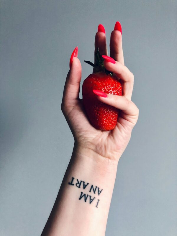 a woman's arm with a small tattoo on it
